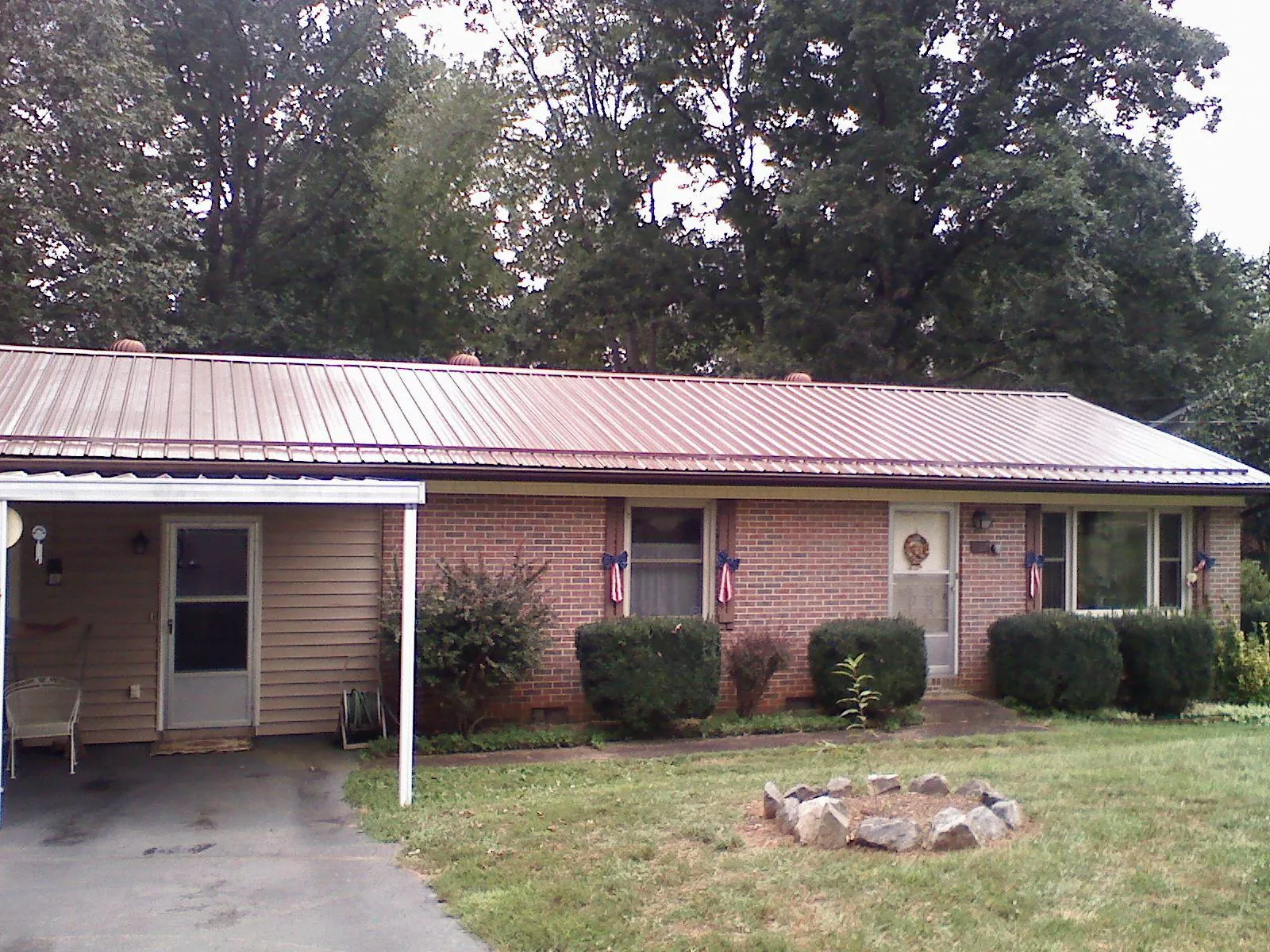 Bronze metal roof and carport on a brick ranch home — Roof Repair work by our crew in Monongahela