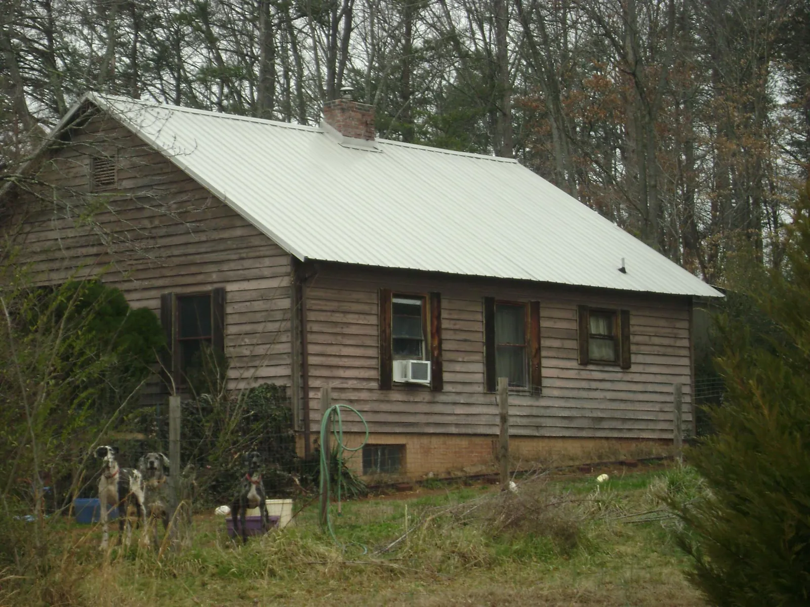 White metal roof on an old wood sided farmhouse, from a Metal Roof Installation job in Monongahela
